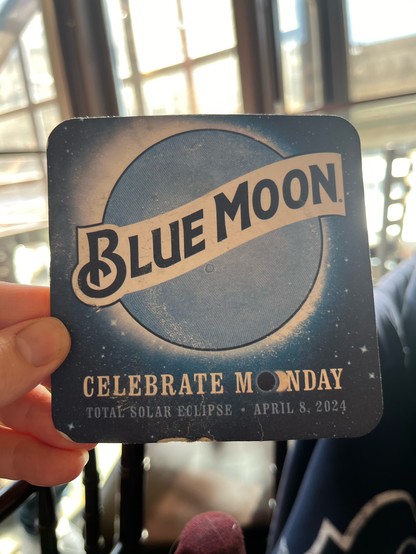 Front side of Blue Moon beer coaster. “Celebrate Monday April 8 2024 solar eclipse”