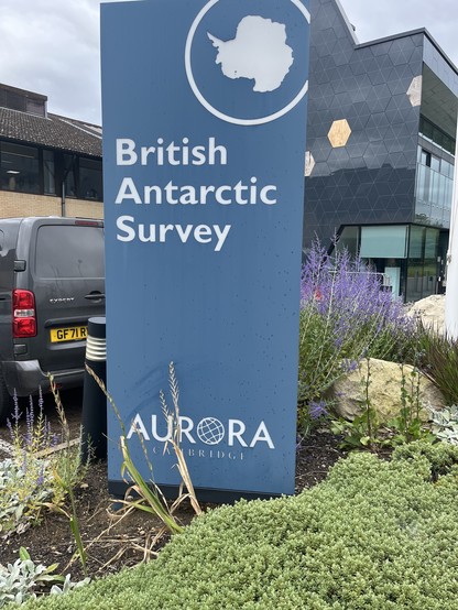 Entrance to the British Antarctic Survey with land-sea mask of Antarctica and “Aurora” on the sign.