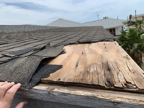 Okay… last photo was deceiving… roof didn’t look SO bad… here the asphalt / tar strips are torn off to reveal a segment of roofless plywood . 

No obvious from photo, but I tell you here this is a regular old home in Surfside Beach, Texas, post July 2024 Beryl.
