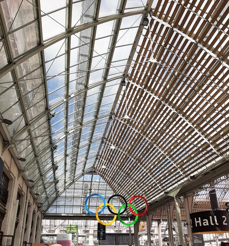 Glass roof of the station looking like the inverted boat hull. The olympic rings hang  in the middle .