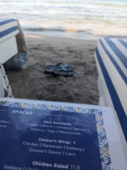 Photo of the snacks menu at a beach bar. One of the options reads:

```
Club Sandwich, 11€
Chicken|Bacon|Cheese|Tomato|Iceberg|Egg|Mayonnaise 
```